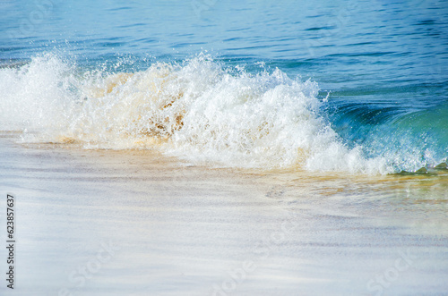 Blue sea wave, white foam, golden sand of sea coast. travel concept, summer vacation, background