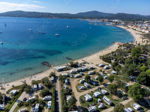 Arial view on blue water of Gulf of Saint-Tropez  sandy beach  houses in Port Grimaud  village on Mediterranean sea with yacht harbour  Provence  summer vacation in France