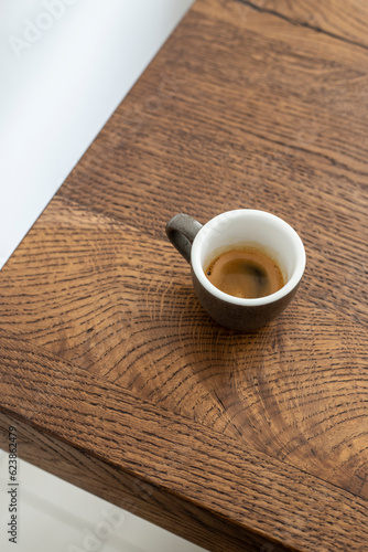 espresso in a gray ceramic cup on a wooden table. espresso. coffee. black coffee. coffee espresso
