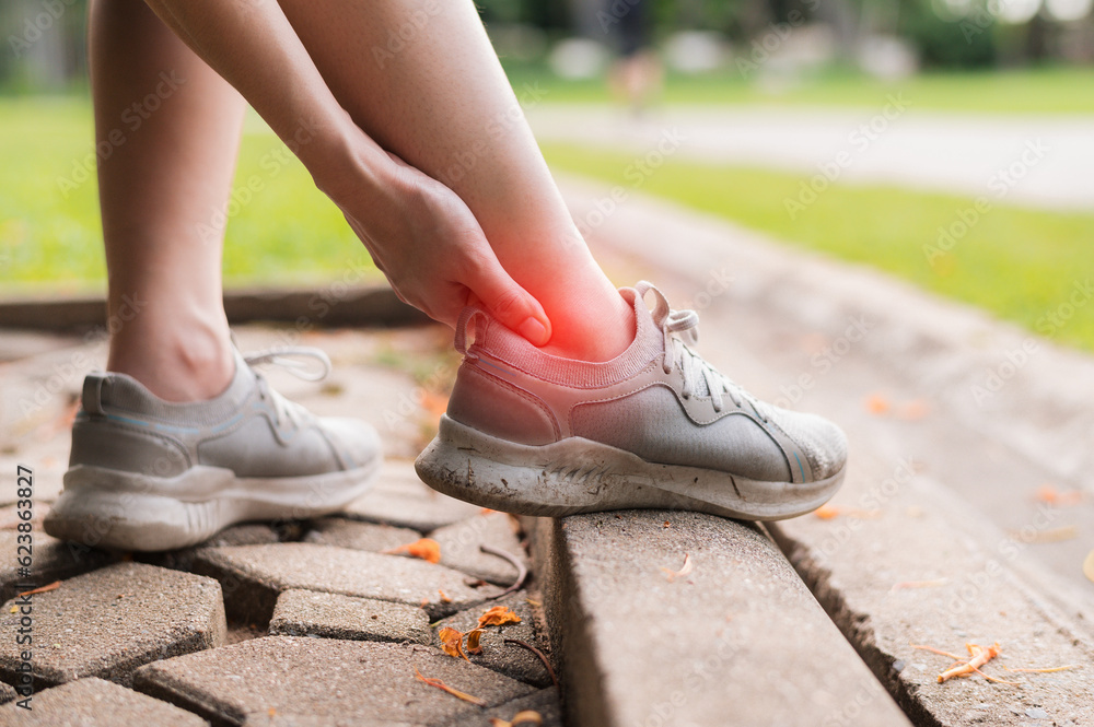 Relief for female joggers dealing with post-run pain. Specialized care for ankle injuries in the public park. Get back on track with treatment concept.