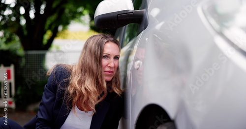 Insurance Agent Inspecting Damaged Car photo