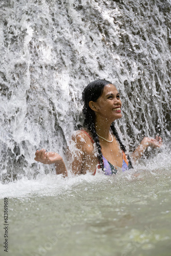 smiling girl in a waterfall