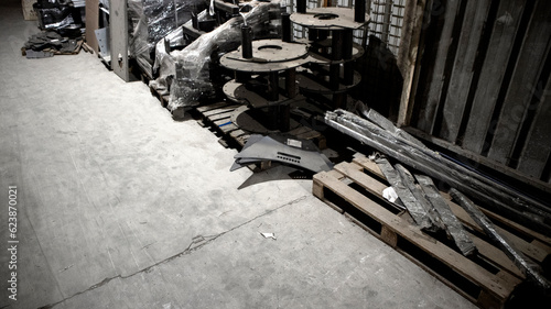 Old parts on the floor of warehouse