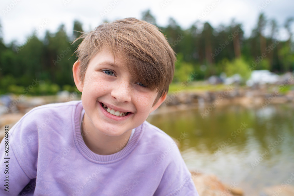 portrait of a happy boy in nature. joyful smiling teenager. portrait of a happy boy in nature. joyful smiling teenager.