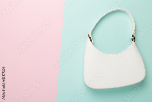 Trendy woman bag on colorful background, top view