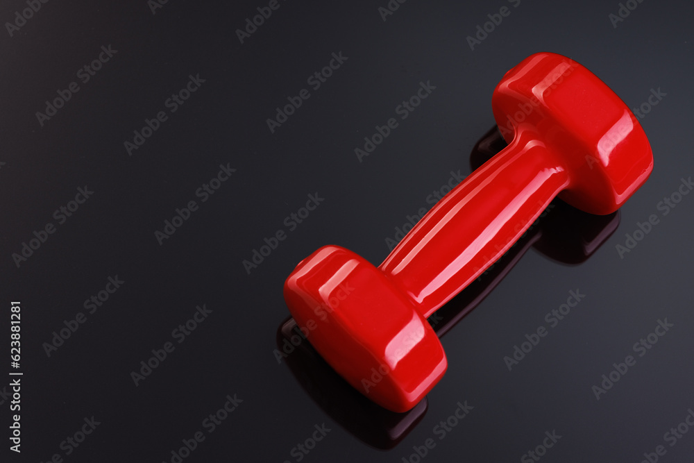 Red shiny with bright highlights on a black mirror background. Close-up. View from above. Red shiny with bright highlights on a black mirror background. Close-up. View from above.