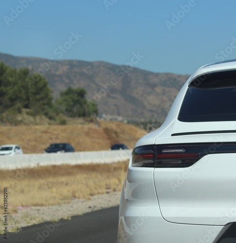 White sport SUV Closeup driving in motion.