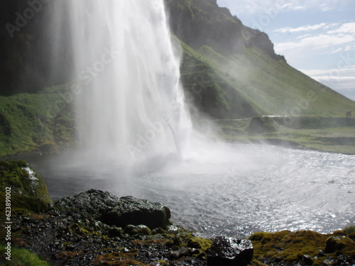 Seljalandsfoss  a waterfall in Iceland flowing into the dark stream