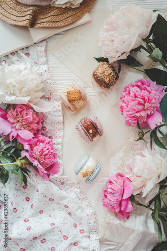 Macaroons and peonies, flat lay top view
