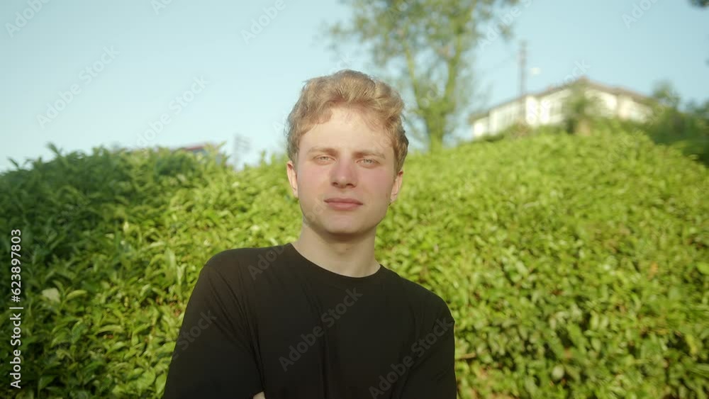 Radiant Smile: Portrait of Handsome Blond Young Male Model with Colored Eyes Gazing at the Camera Outdoors Radiant Smile: Portrait of Handsome Blond Young Male Model with Colored Eyes Gazing at the Camera Outdoors