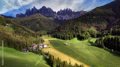 Stunning Alpine scenery of breathtaking Dolomites rocks mountains in Italian Alps, South Tyrol, Italy. Aerial view of Val di Funes and village Maddalena, Valley Isarco photo