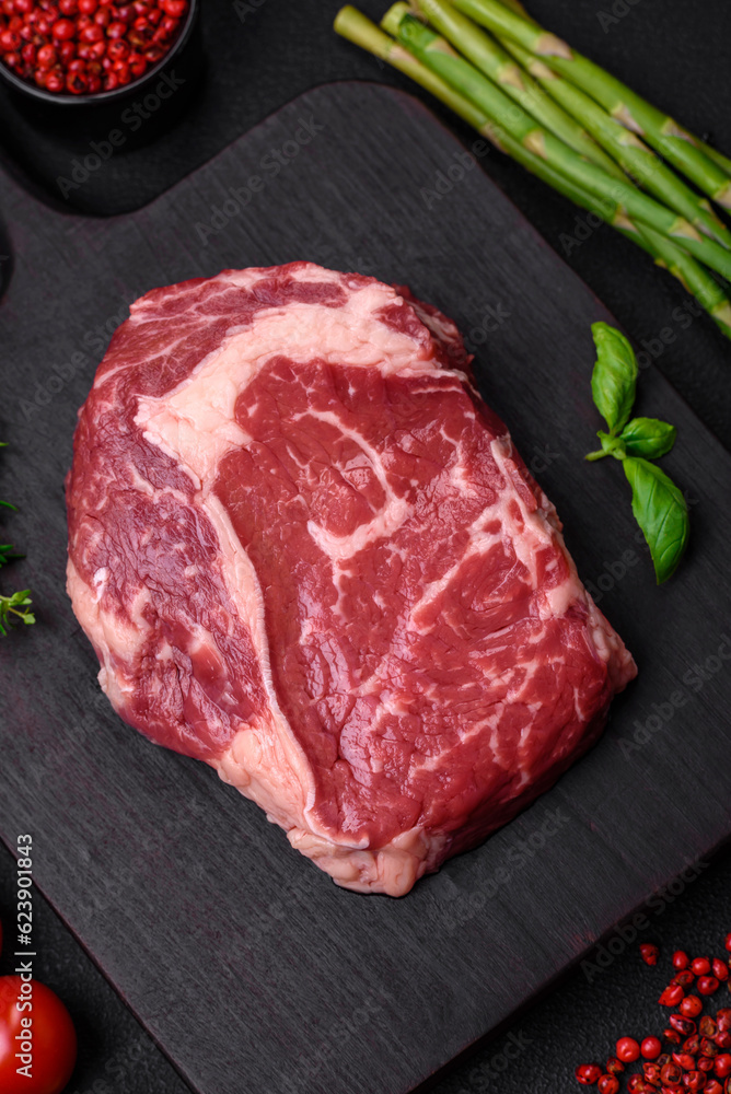 Fototapeta premium Fresh, raw beef steak with salt, spices and herbs