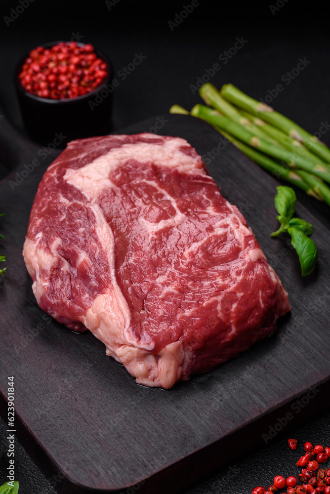 Fresh, raw beef steak with salt, spices and herbs