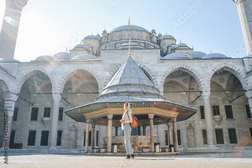 Photography A young female traveler with a backpack on her back walks towards the Fatih Mosq