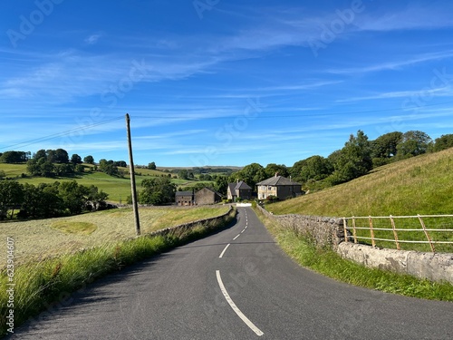 Evening view, down the, Clitheroe to Skipton road, with fields and houses near, Slaidburn, UK