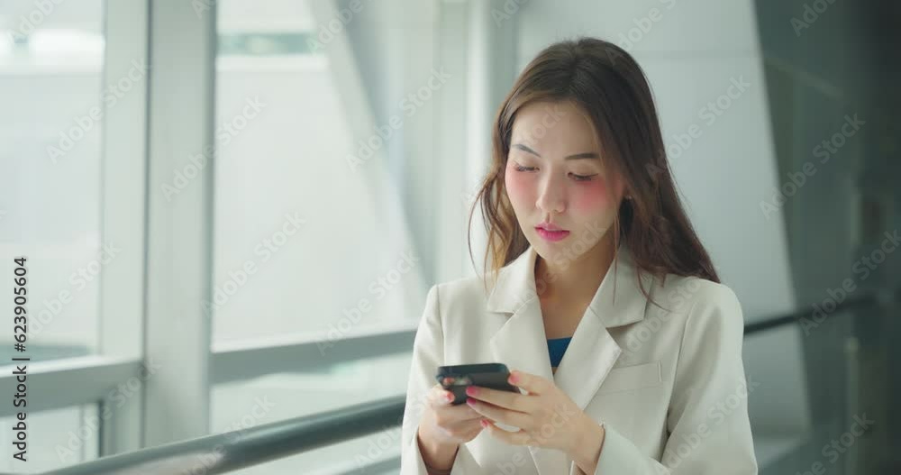 Beautiful asian woman looking her phone at office. She using phone to sending email or chat in break time. Beautiful asian woman looking her phone at office. She using phone to sending email or chat in break time.