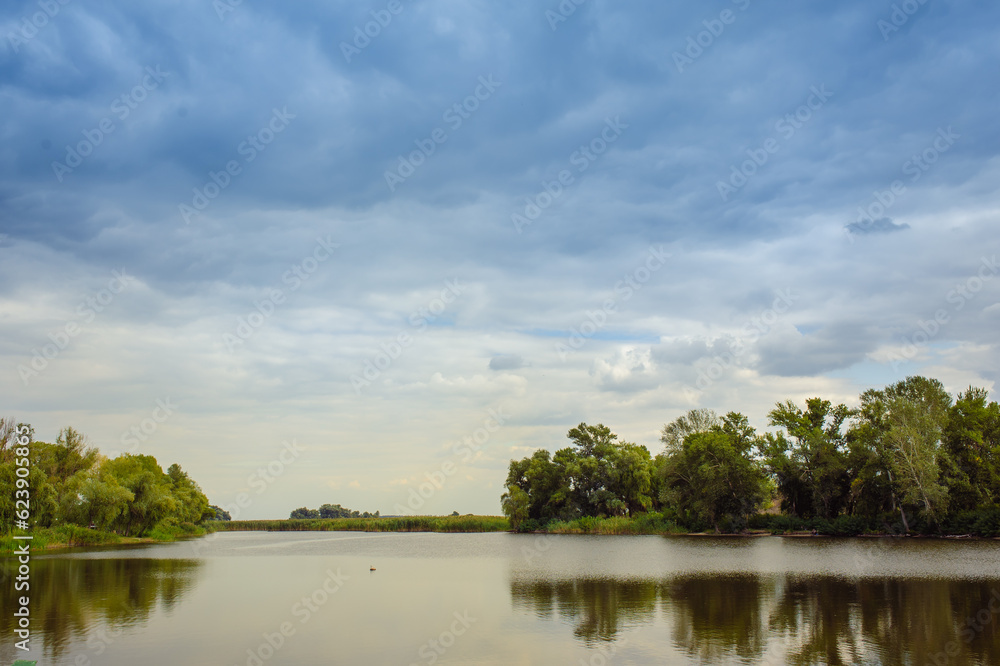 Fototapeta premium beautiful lake at the evening. Landscape - meadow, the blue sky and river