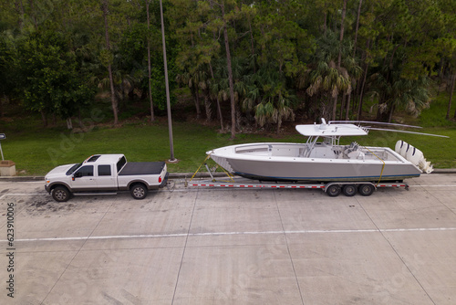 pickup truck with boat on parking lot