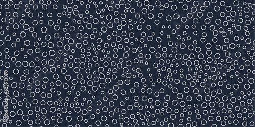 Rings on a black background. Vector pattern of circles  scattered over the surface. For prints and seamless coverings such as wallpapers, cushions, packaging.