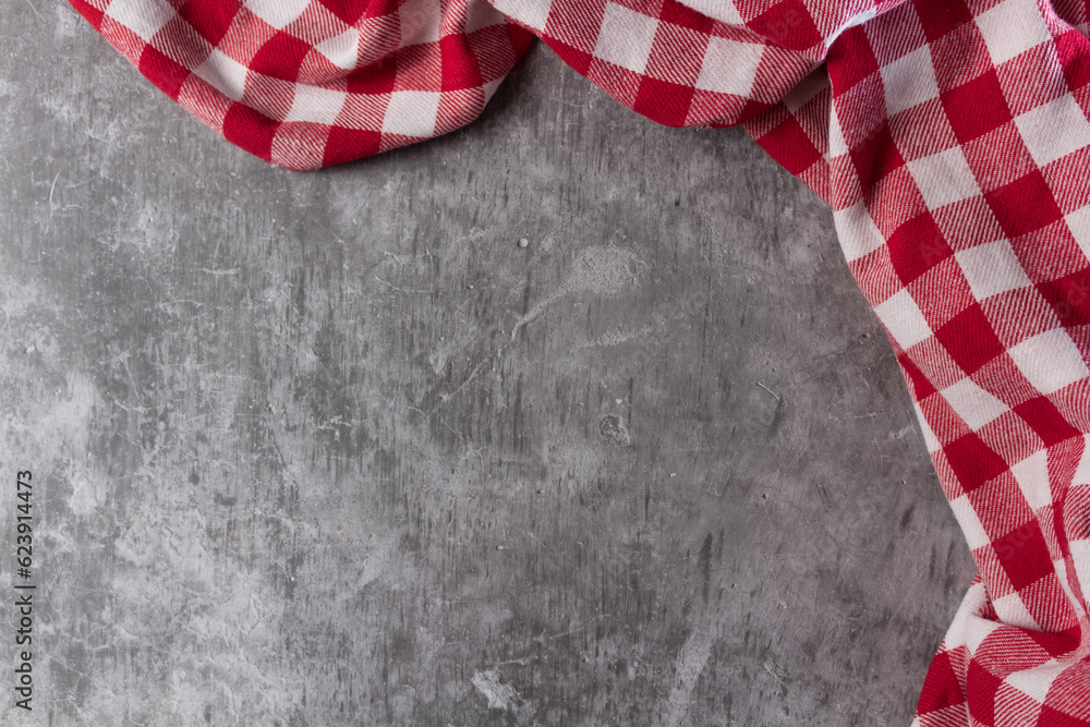 Fototapeta premium red and white tablecloth on a concrete table