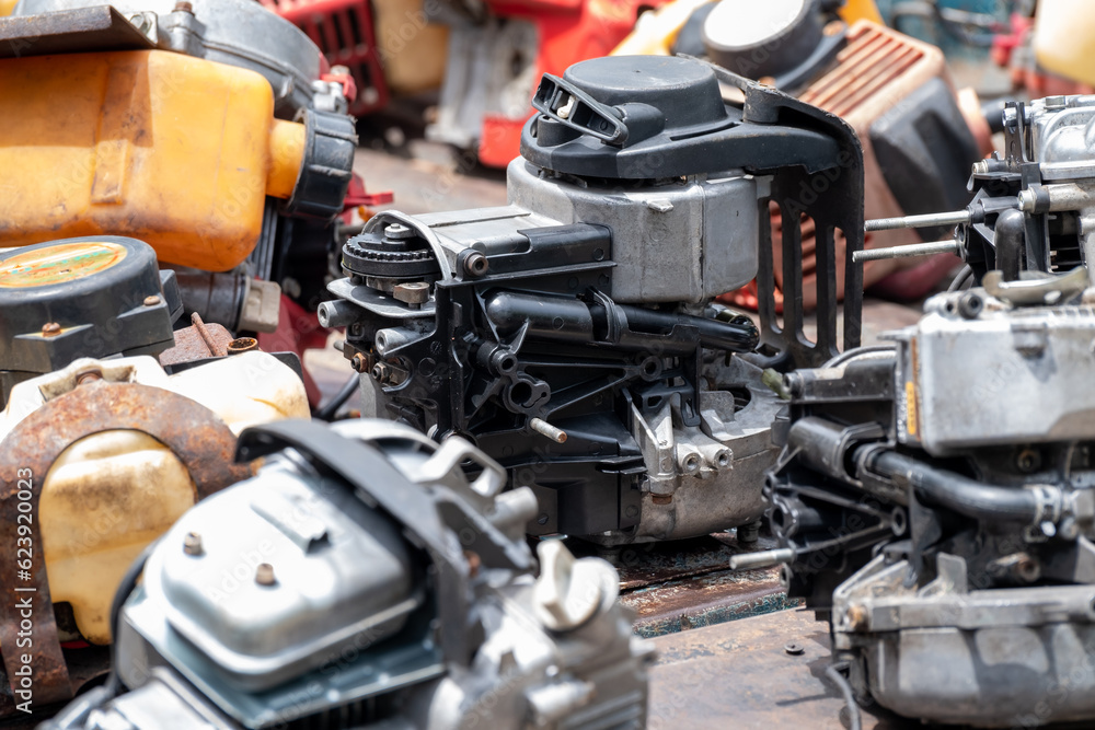 Fototapeta premium The engine of the old lawn mower is a household item, the small engine while being modified to repair the internal parts to be able to use normally
