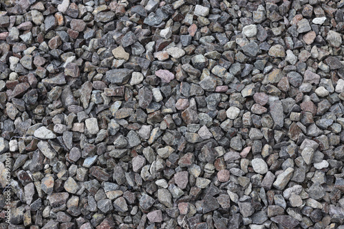 Gravel texture background. Pebble sea beach close-up, dark wet pebble and gray dry pebble.
