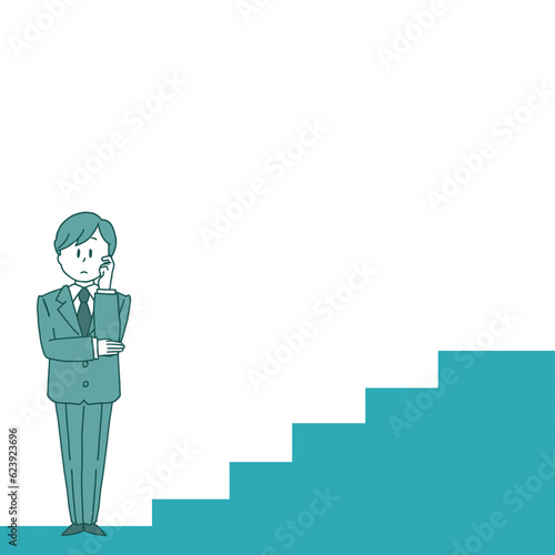 A man at the bottom of the stairs pondering how to climb