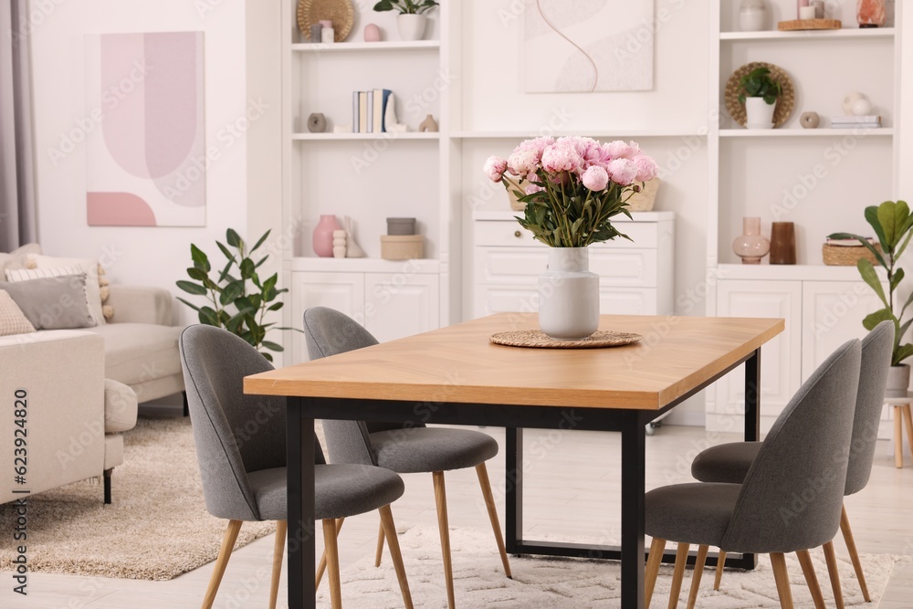Stylish dining room with cosy furniture and flowers Stylish dining room with cosy furniture and flowers