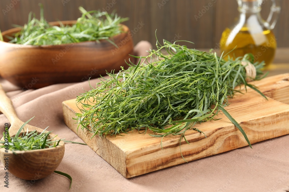 Fresh green tarragon sprigs on pink tablecloth Fresh green tarragon sprigs on pink tablecloth