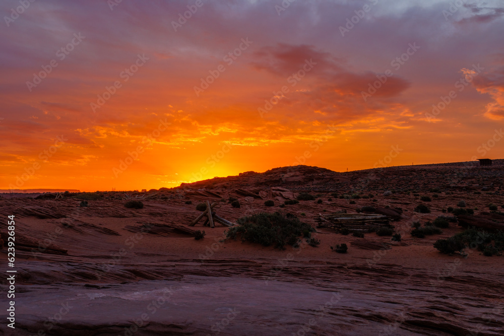 Naklejka premium Orange sunrise with clouds in the desert near Page, Arizona during spring 