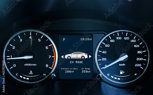 A low light picture with noise effect of car dashboard meter with indicator and EV mode. Car hybrid and electric concept