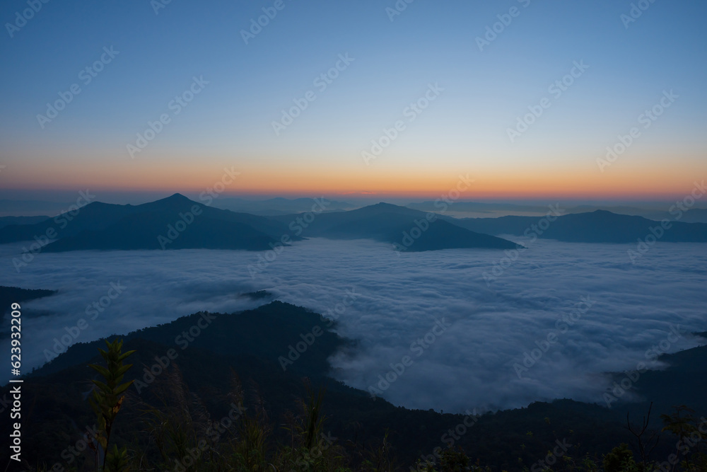 Beautiful landscape on the mountains against sky during sunrise. Spectacular view in foggy valley covered forest under morning sky. Countryside landscape view background.