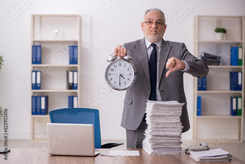 Old male employee in time management concept