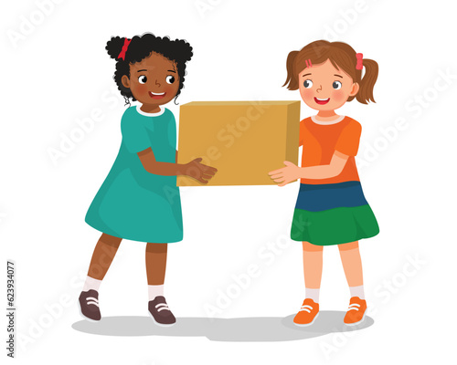 Two little girl carrying and moving box together