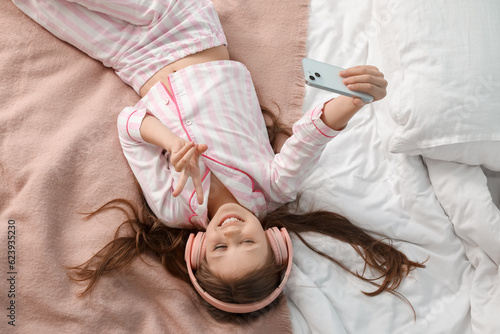 Little girl with headphones...