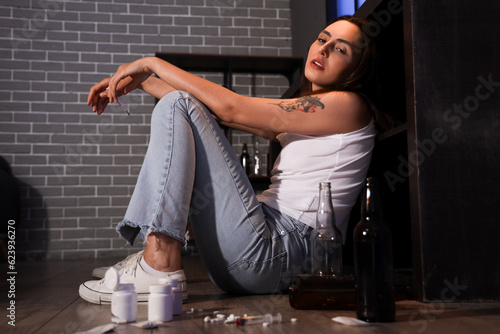 Tableau sur toile Female drug addict with syringe at home in evening