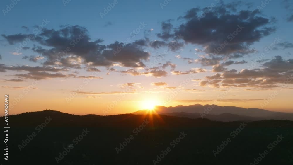 Aerial view of sun setting over San Bernardino Mountains in area of Lake Arrowhead, Los Angeles, California, USA. Drone shot of magic sunset with clouds on colorful sky. Natural background, 4k footage Aerial view of sun setting over San Bernardino Mountains in area of Lake Arrowhead, Los Angeles, California, USA. Drone shot of magic sunset with clouds on colorful sky. Natural background, 4k footage