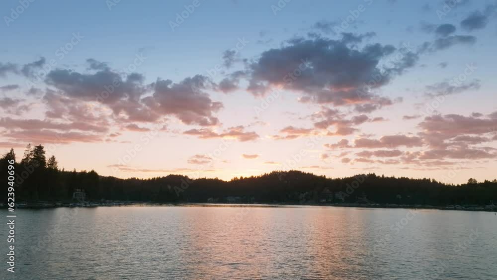 Aerial view of picturesque Lake Arrowhead in the San Bernardino Mountains at dusk, Los Angeles, California, USA. Fluffy clouds on sunset sky. Village on lakeside surrounded mountains, 4k footage Aerial view of picturesque Lake Arrowhead in the San Bernardino Mountains at dusk, Los Angeles, California, USA. Fluffy clouds on sunset sky. Village on lakeside surrounded mountains, 4k footage