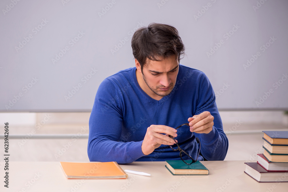 Young male student preparing for exams in the classroom Young male student preparing for exams in the classroom