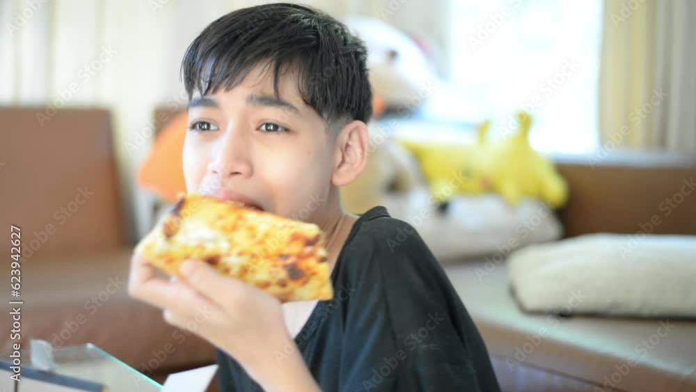 Boy is eating a piece of pizza ready to eat Boy is eating a piece of pizza ready to eat