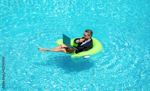 adult business man trading online. business man trading online in swimming pool. business man © be free
