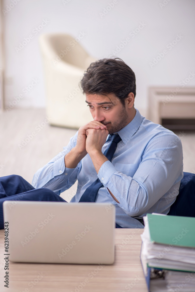 Young male employee working in the office Young male employee working in the office