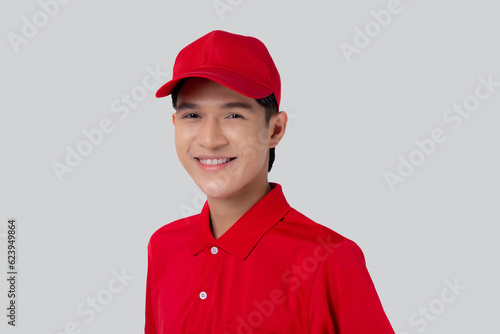 Portrait young asian man in uniform standing and smile with confident isolated white background, employee or dealer, courier and delivery, deliveryman and expression, logistic and cargo, one person.