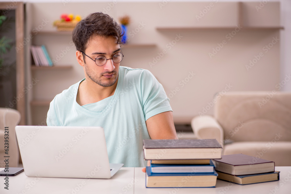 Young male student preparing for exams at home Young male student preparing for exams at home