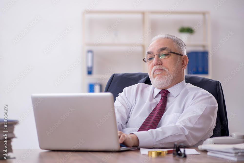 Old male employee and too much work in the office Old male employee and too much work in the office