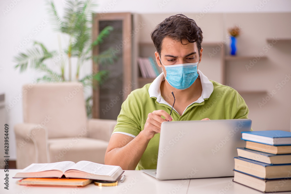 Young male student preparing for exams at home during pandemic Young male student preparing for exams at home during pandemic