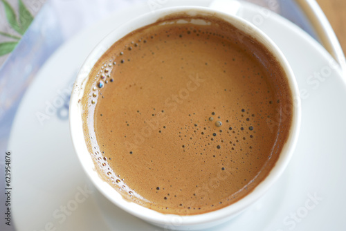 top view of hot coffee with bubble on white background 