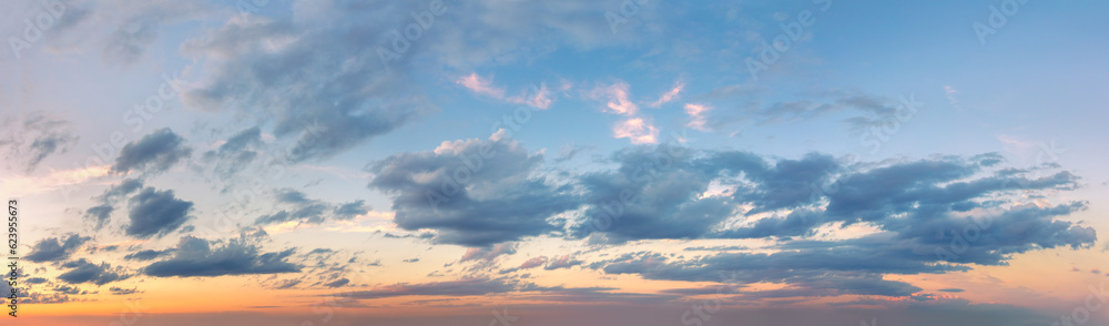 Extra wide panorama of the sunset sky. Light colored clouds. No birds in the sky. Sunrise Sundown Sunset