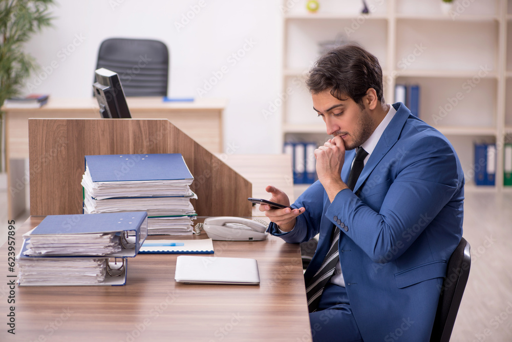 Young male employee working in the office Young male employee working in the office