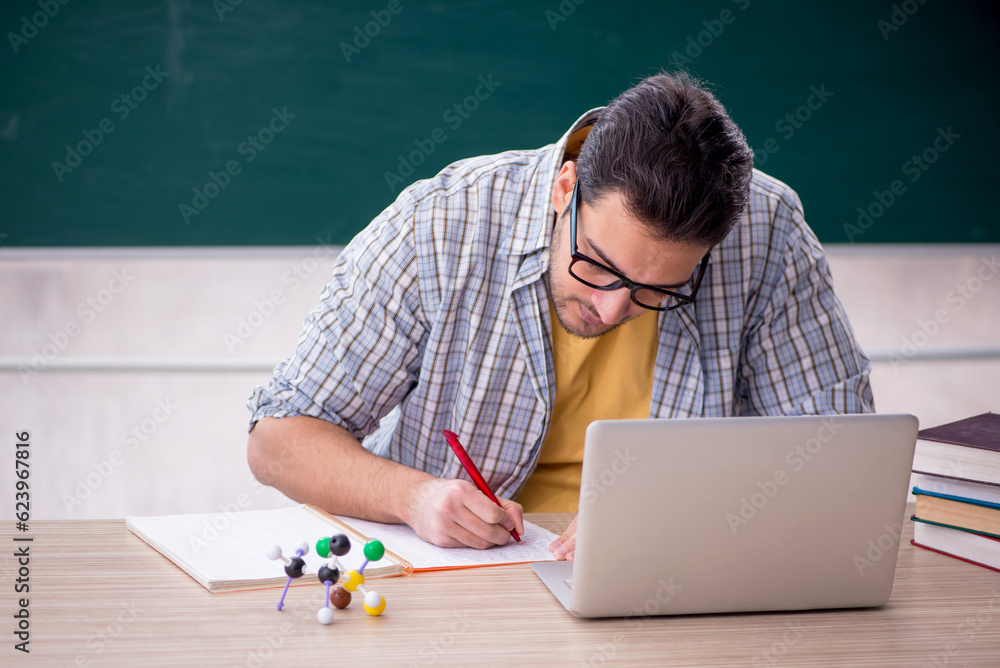 Young male student sitting in the classroom Young male student sitting in the classroom